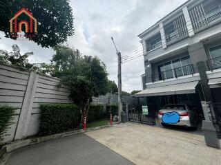 Front view of a residential building with parking and driveway