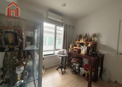 Cozy room with religious artifacts and display cabinet