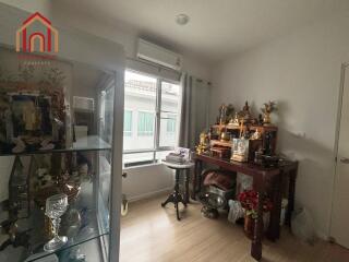 Cozy room with religious artifacts and display cabinet