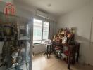 Cozy room with religious artifacts and display cabinet