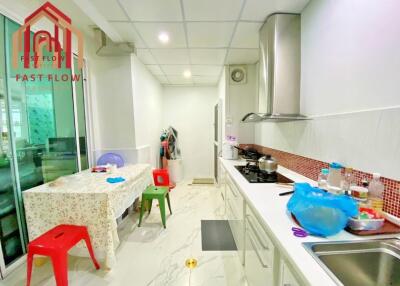 Bright and modern kitchen with dining area, stove, and storage