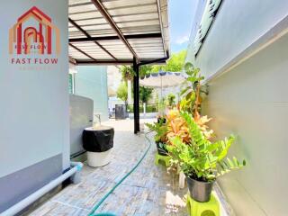 Covered outdoor walkway with plants and seating