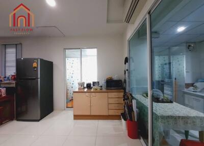 Modern kitchen with black refrigerator and appliances