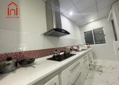 Modern kitchen with white cabinetry and stainless steel appliances