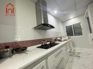 Modern kitchen with white cabinetry and stainless steel appliances