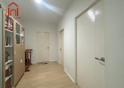 Spacious Hallway with Wooden Flooring and Bookshelf