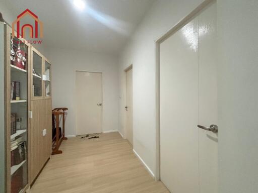 Spacious Hallway with Wooden Flooring and Bookshelf