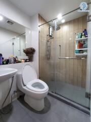 Modern bathroom with toilet, sink, and shower