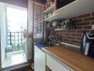 Compact modern kitchen with appliances and a balcony view