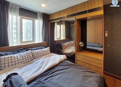 Cozy modern bedroom with large windows and mirrored wardrobe