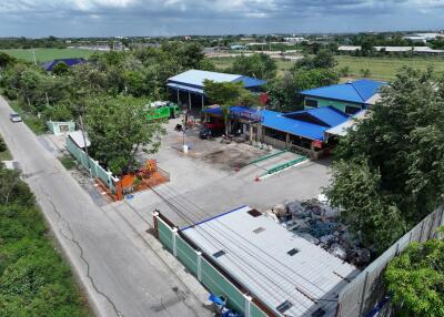 Aerial view of a residential or commercial property with multiple buildings and open spaces.