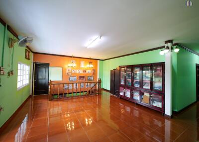 Spacious living area with colorful walls and tile flooring