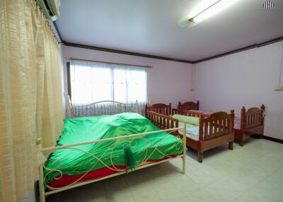 spacious bedroom with a large window and two beds