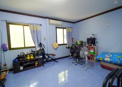 Bedroom with fitness equipment and workspace