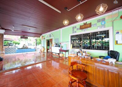 Spacious lobby area with check-in counter and pool view