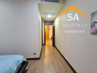 Bedroom with wooden flooring and wall art