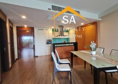 Modern dining room with table setup and view into kitchen