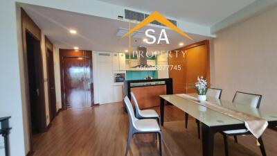 Modern dining room with table setup and view into kitchen