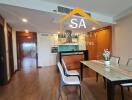 Modern dining room with table setup and view into kitchen