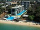 Aerial view of modern beachfront apartments with swimming pools