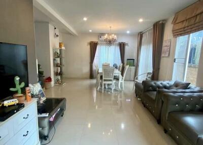 Well-lit living room with seating area and dining table