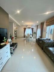 Well-lit living room with seating area and dining table