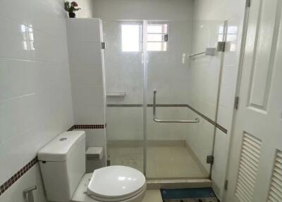 Modern bathroom with glass shower door and white fixtures