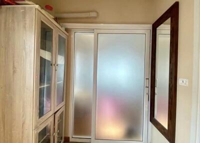 Entryway with storage cabinet and frosted glass sliding door