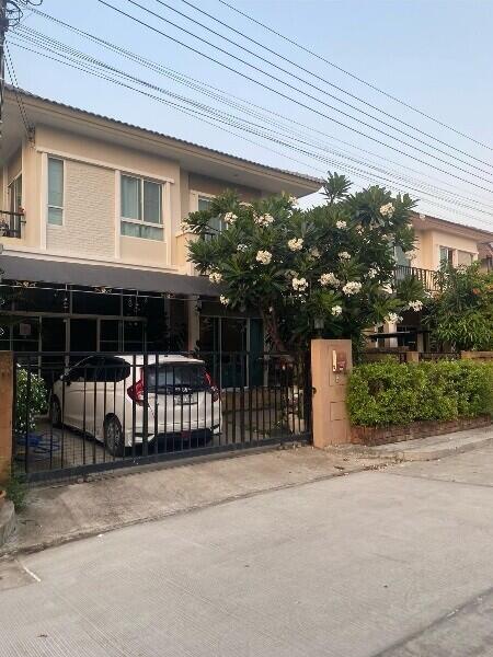 Two-story house with a carport and garden