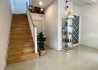 Foyer with stairs and display cabinet