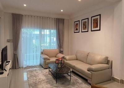 Modern living room with white furniture and wall art