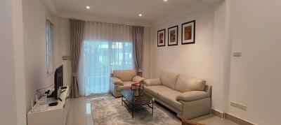 Modern living room with white furniture and wall art