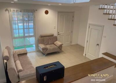 Cozy living room with light-colored sofas and a large window