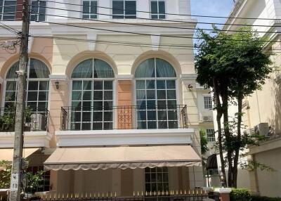 Three-story residential building with balcony and garage