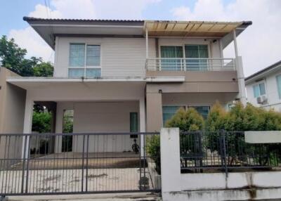 Front view of a modern two-story house with fenced yard