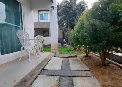 Outdoor patio area with chairs and trees