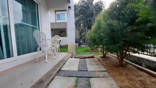 Outdoor patio area with chairs and trees