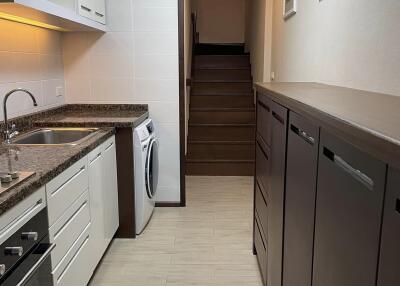 Modern kitchen with granite countertops and stairway