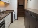 Modern kitchen with granite countertops and stairway