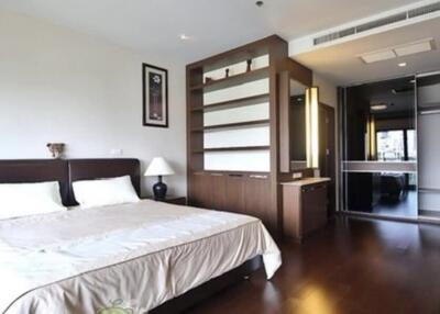 Spacious modern bedroom with ample storage and large windows