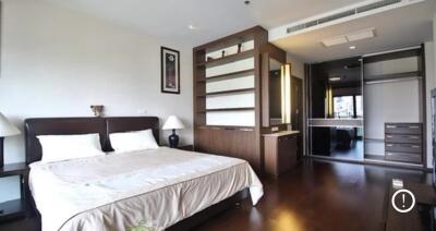 Spacious modern bedroom with ample storage and large windows