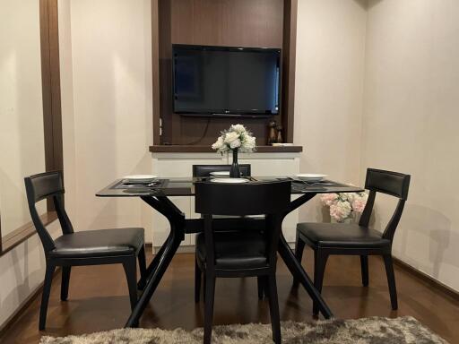 Dining room with glass-top table and chairs