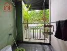 Covered balcony area with greenery view