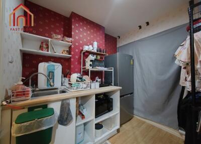 Compact kitchen with red patterned wall