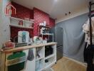 Compact kitchen with red patterned wall