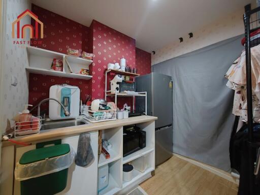 Compact kitchen with red patterned wall