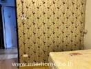 Bedroom with floral wallpaper and mattress