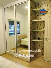 Bedroom with a mirror wardrobe and decorative shelving