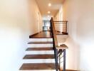 wooden staircase with metal railings in a modern home