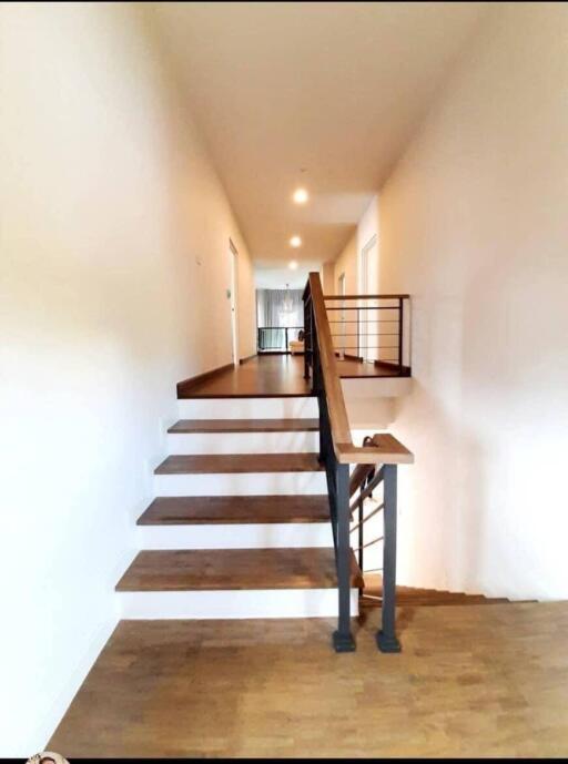 wooden staircase with metal railings in a modern home